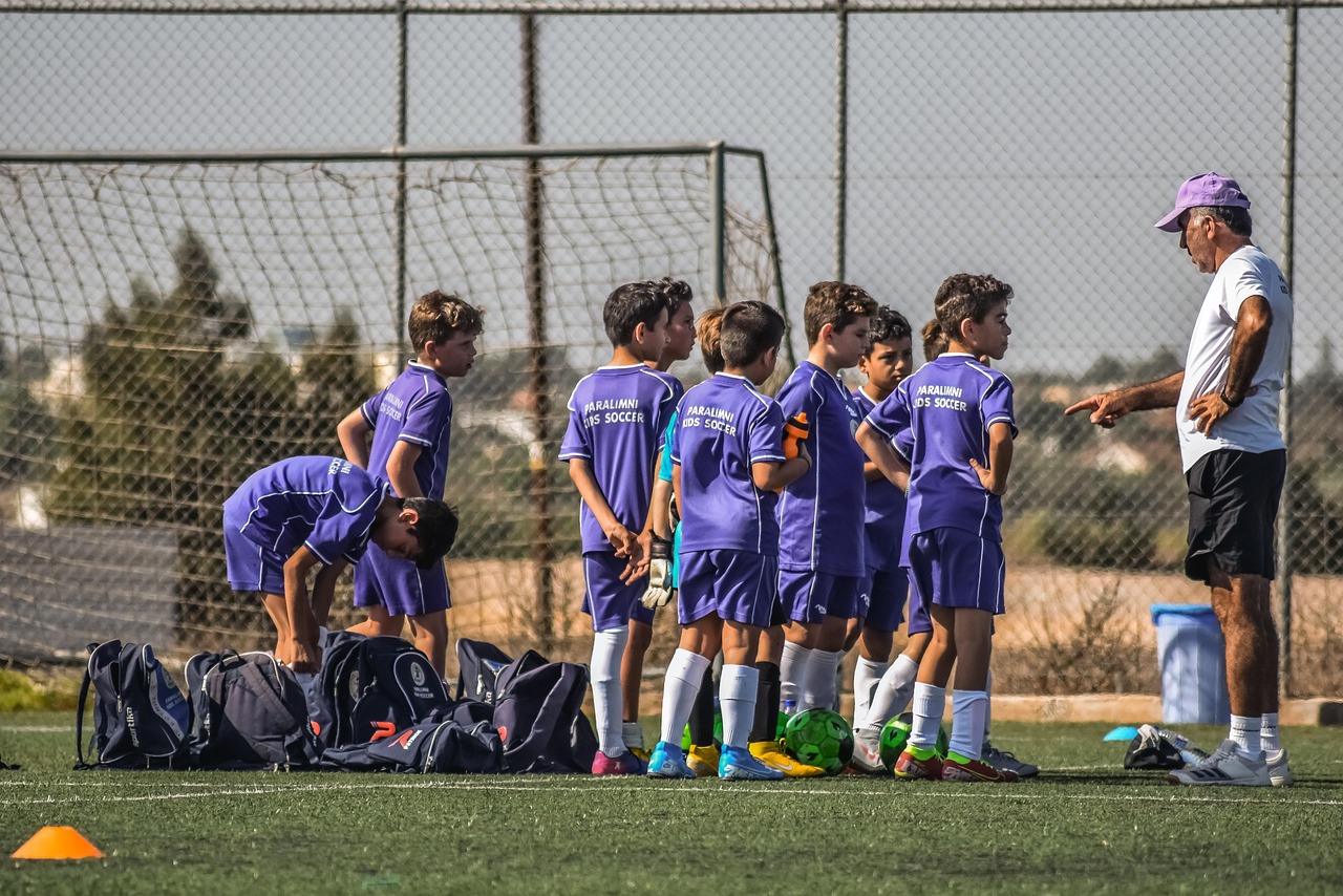 Young football player training on field
